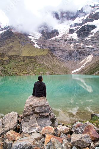 man in front of the Humantay Lake on the Salkantay Trail, the trek to Machu Picchu, Peru