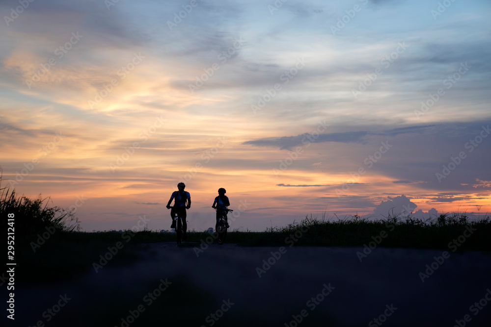 Asian couple cycling on the countryside . Asian couple cycling on the countryside .