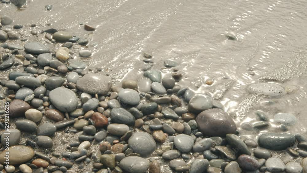 Water splashing over stones at a beach 15 seconds Water splashing over stones at a beach 15 seconds