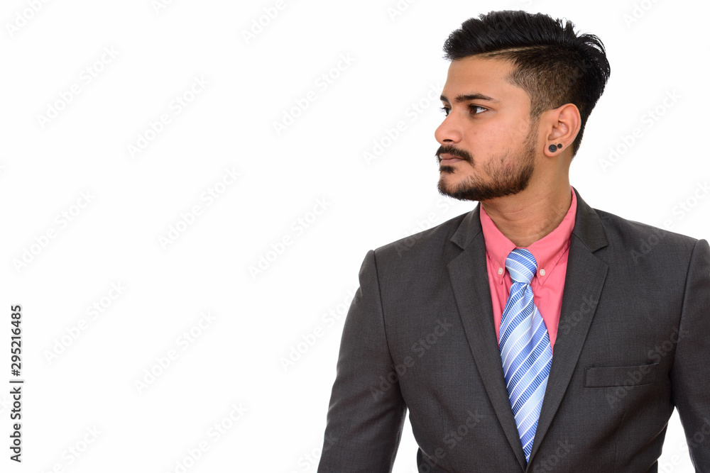 Side view of young handsome Indian businessman Side view of young handsome Indian businessman