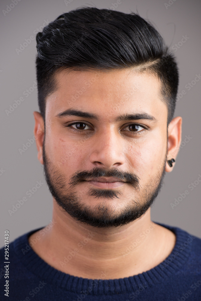 Face of young handsome Indian man looking at camera Face of young handsome Indian man looking at camera