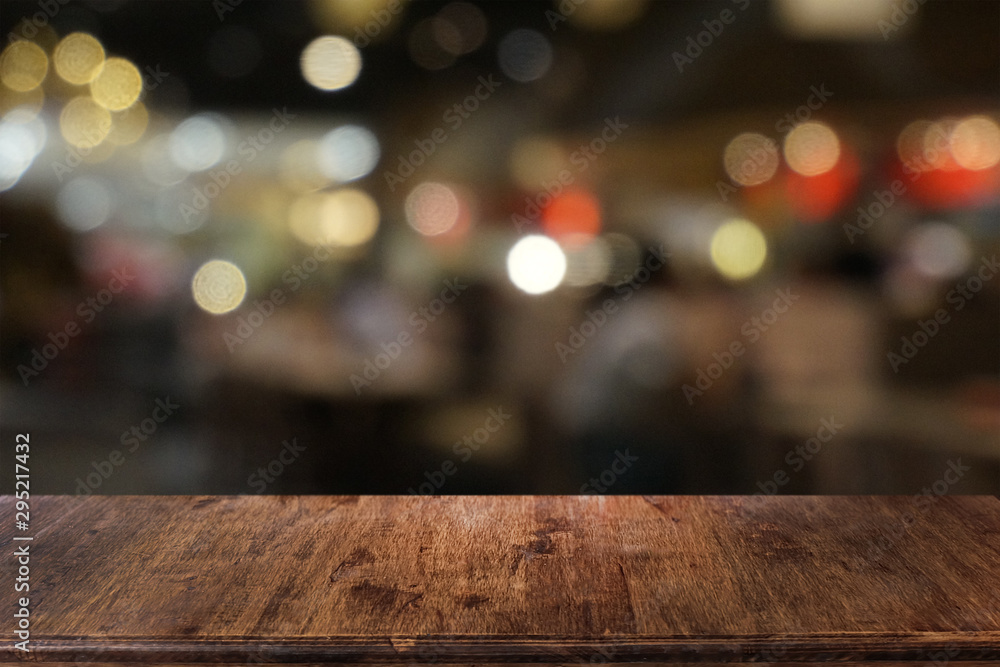 Empty dark wooden table in front of abstract blurred bokeh background of restaurant . can be used for display or montage your products.Mock up for space.