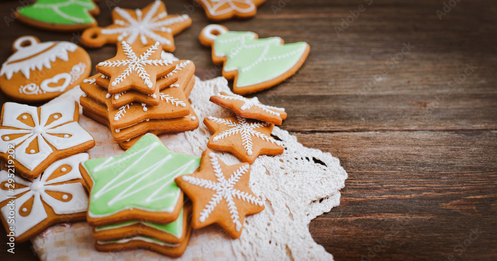 festive Christmas gingerbread cookies in the shape of a star lie on a wooden dark brown background. festive Christmas gingerbread cookies in the shape of a star lie on a wooden dark brown background.