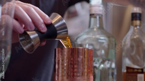 Bartender poouring shots into shaker photo