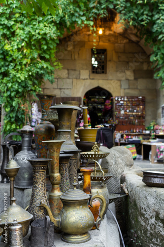 Old oriental antiques barass jungs and vases on street market in Baku, Azerbeijan. photo