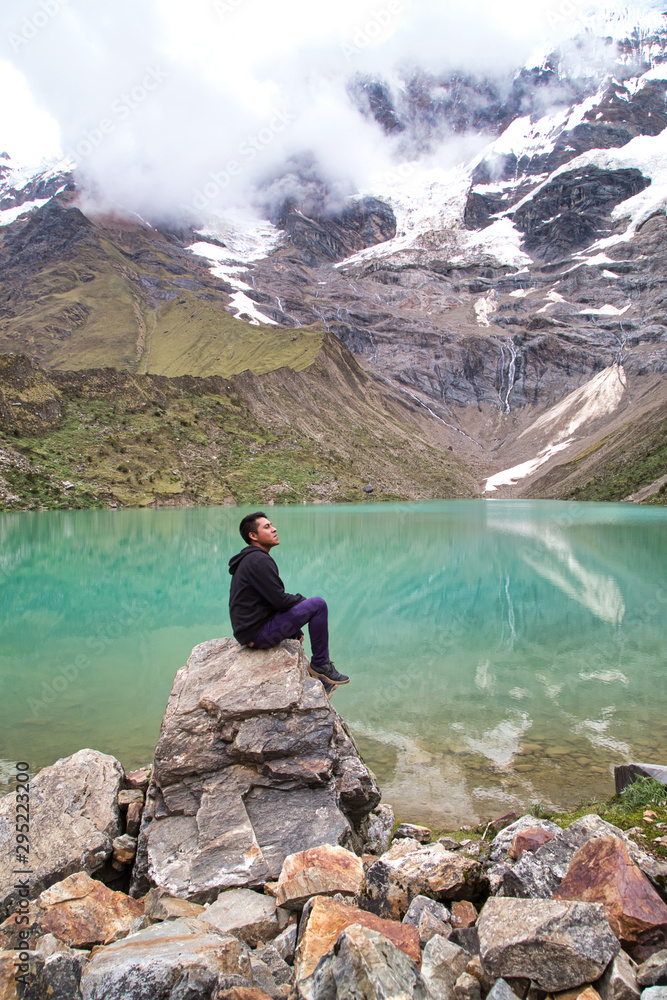 man in front of the Humantay Lake on the Salkantay Trail, the trek to Machu Picchu, Peru man in front of the Humantay Lake on the Salkantay Trail, the trek to Machu Picchu, Peru