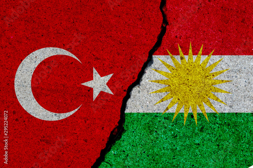 turkey and kurdistan flags painted over cracked concrete wall photo