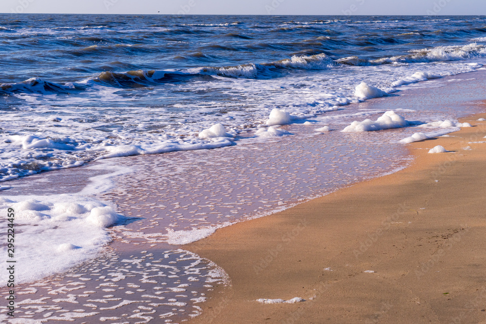 Image of sea foam on a sandy beach. Image of sea foam on a sandy beach.