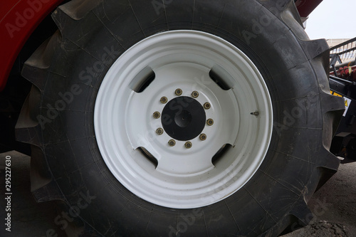 large tires with a large tread on a new agricultural tractor after assembly at the plant on a sunny day