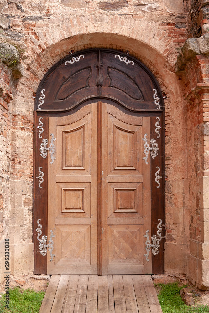 Door with ornaments at Marianska Tynice a former pilgrimage destination in Bohemia, now Czech Republic, with Baroque Church of the Annunciation built in the 18th century. Týnec, CZ.