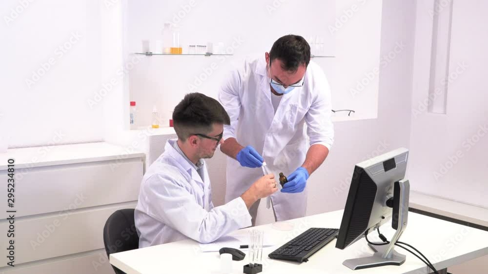 Two lab workers research microbiology Two lab workers research microbiology