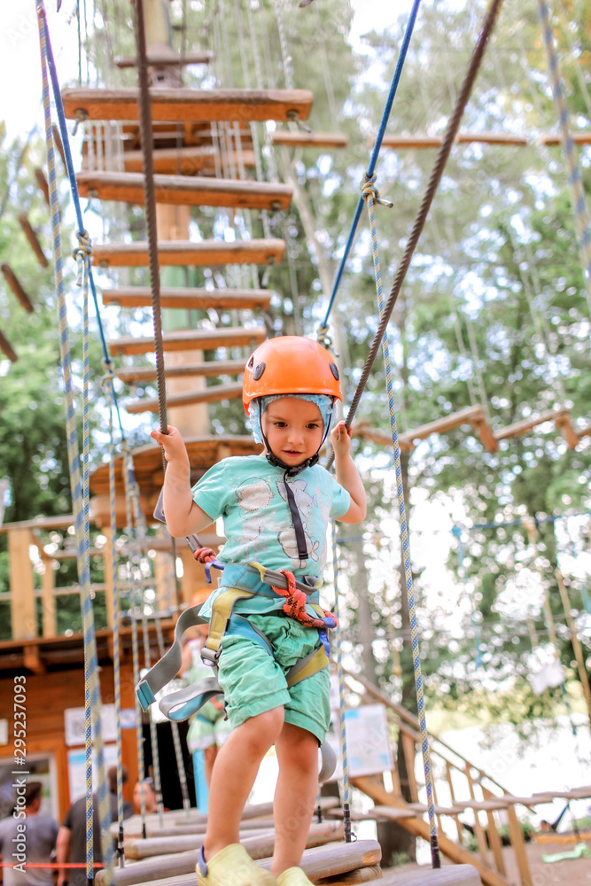 Boy enjoying time in a rope structure at adventure park