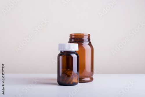 Small and Large Blank dietary supplement bottle and medicine set on a white background.