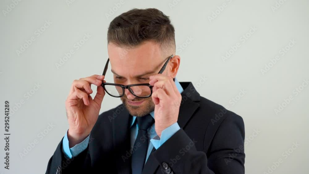 Portrait of a formally dressed bearded man with glasses looking at the camera Portrait of a formally dressed bearded man with glasses looking at the camera