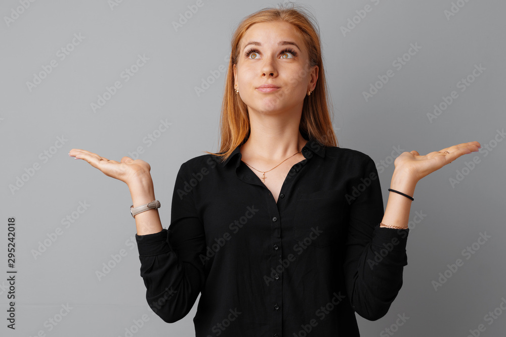 Young beautiful woman portrait being excited and amazed over gray background. Young beautiful woman portrait being excited and amazed over gray background.