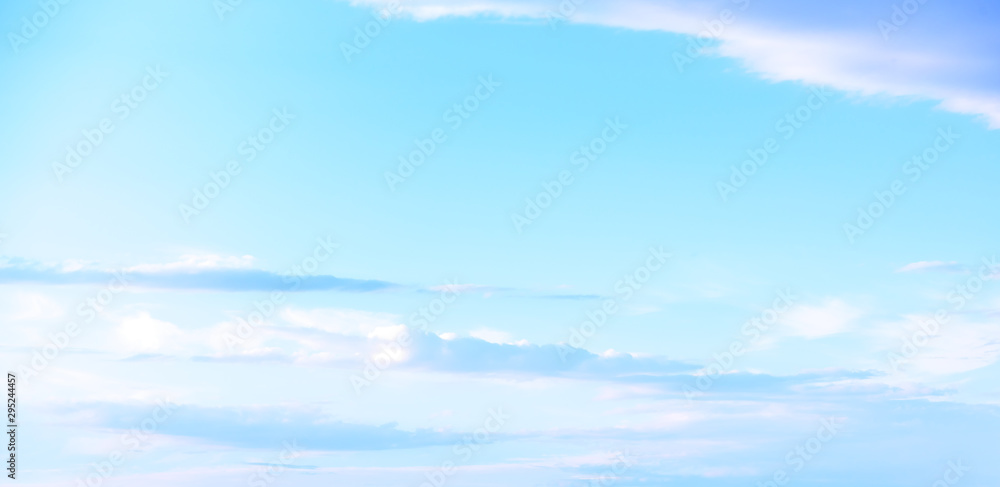 Beautiful pastel colored clouds at sunset isolated against blue skies Beautiful pastel colored clouds at sunset isolated against blue skies