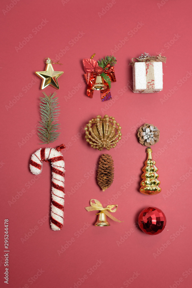 Christmas composition of Christmas toys, candy and spruce branches on a red background. template for postcards