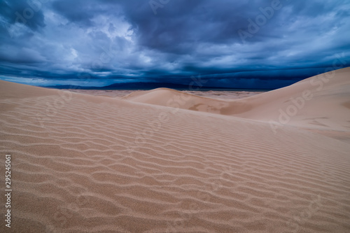 Storm clouds over sand dunes in the desert