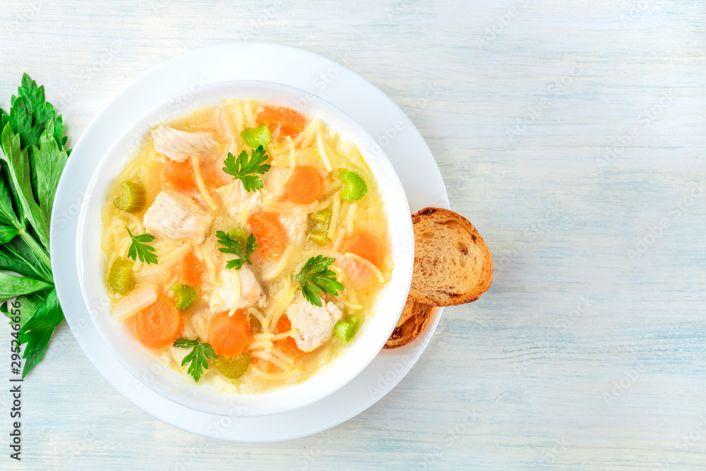 Chicken noodle soup, shot from above with toasted bread and a place for text