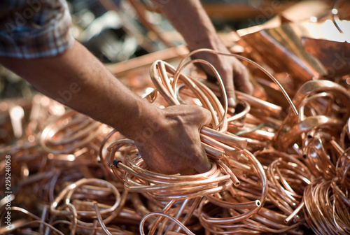 hands of worker with bronze tubes