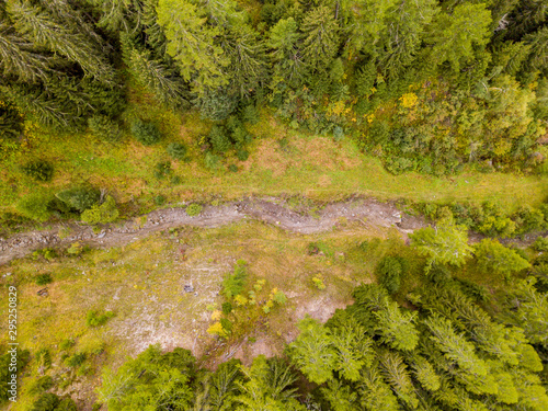 Aerial view of mud slide river bed in mountain forest in Switzerland.