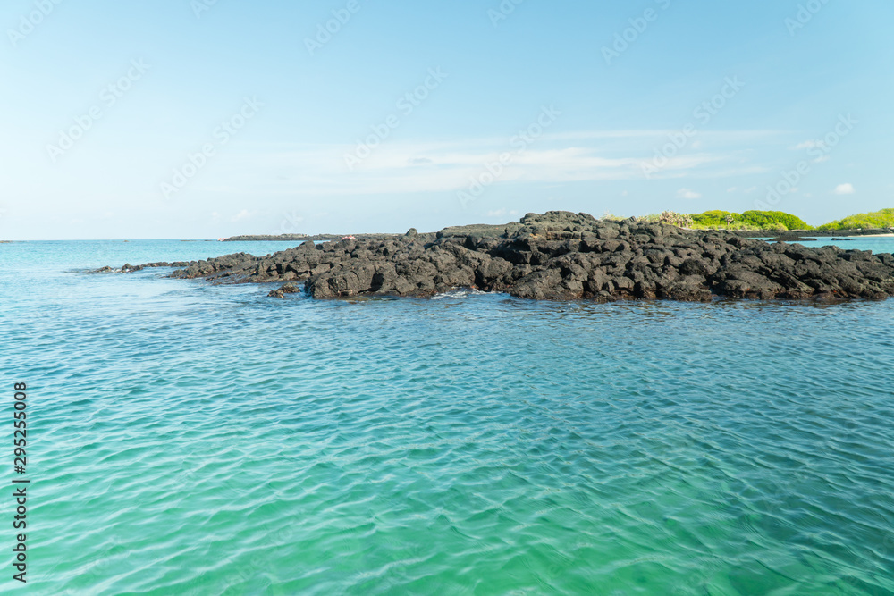 Clear blue sea, rocks, beach and scenic water views. Beautiful scenic water shots with coastline. Shot on Galapagos Islands. Turquoise blue sea. Holiday, vacation, paradise, tropical concepts