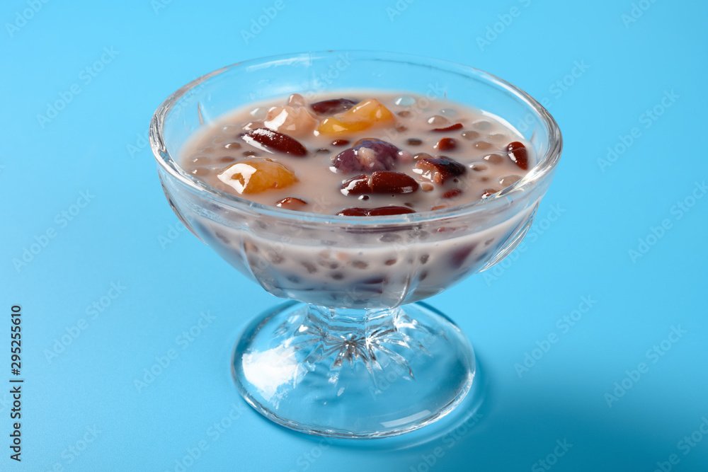 side view Chinese syrup of red bean and sago with shredded coconut on blue background side view Chinese syrup of red bean and sago with shredded coconut on blue background