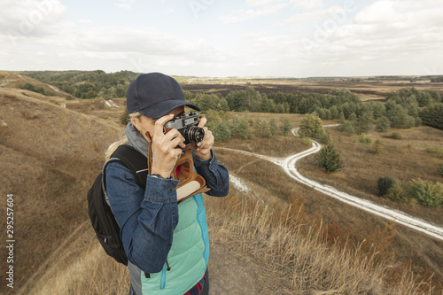 Front view woman with camera outdoor