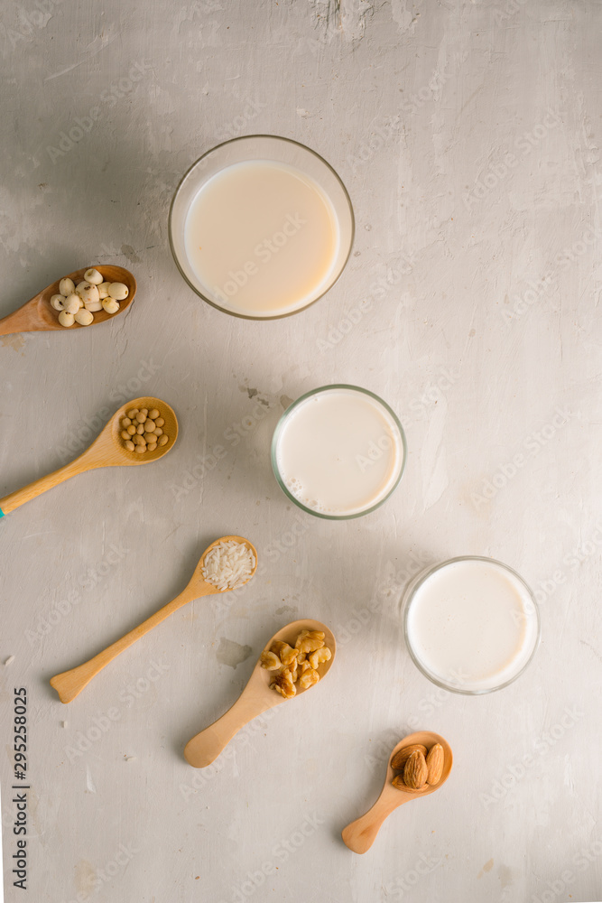 Glasses of milk with nuts: Macadamia, almond, soy, rice, lotus. Top view. Glasses of milk with nuts: Macadamia, almond, soy, rice, lotus. Top view.