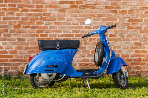 Old Blue Vespa parked on green lawn in Rome  Italy