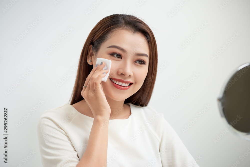 beautiful girl cleans the face of makeup with a cotton pad beautiful girl cleans the face of makeup with a cotton pad