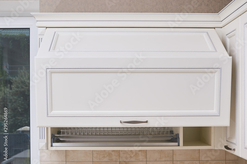 dish drying rack in Hanging cabinets with milling and cornices in white classic kitchen