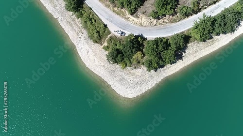 Aerial of Turquoise Lake Water and Coast With Coastal Road in Serbia photo