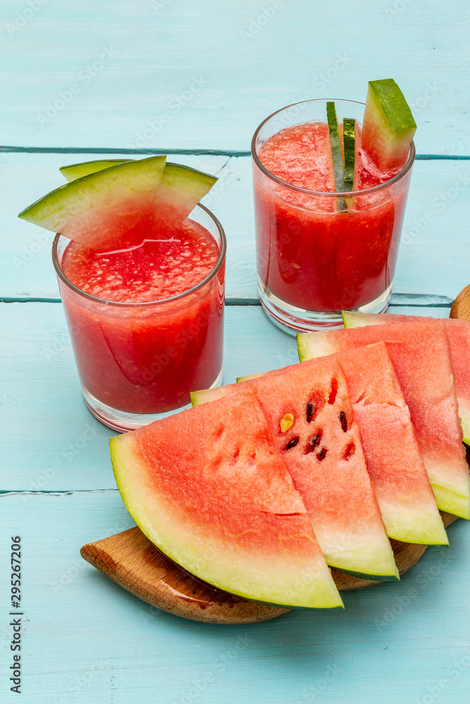 Fresh juice of watermelon, smoothie, cocktail. Sweet summer dessert, slices on wooden cutting board Fresh juice of watermelon, smoothie, cocktail. Sweet summer dessert, slices on wooden cutting board