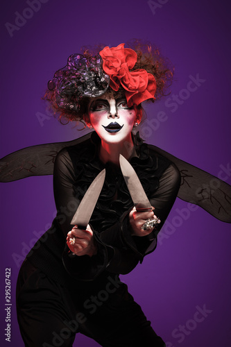 A closeup of a scarier clown female Holding Knife photo