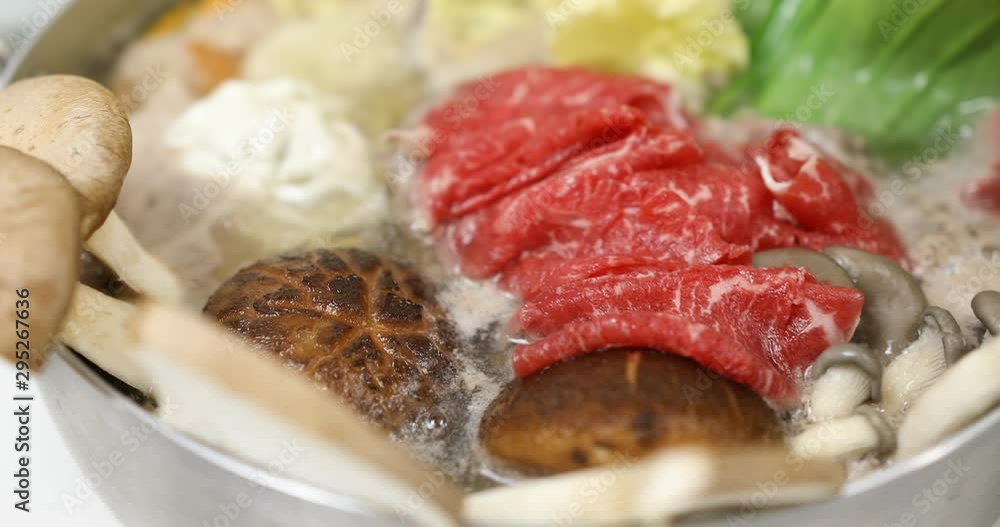 Boiling vegetables and beef in hot pot : shabu shabu Boiling vegetables and beef in hot pot : shabu shabu