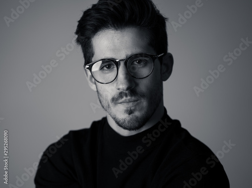 Young attractive latin man with glasses posing looking sensual and handsome. Beauty concept and lifestyle