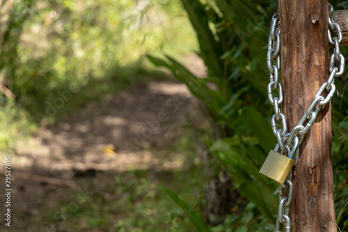 Locker with chain close up with blurred green background and copy space. Padlock secret symbol outdoors