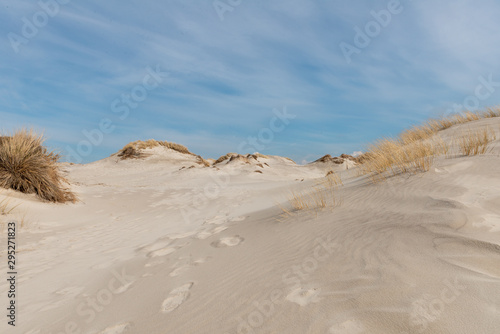 Sandy dune tops with a blue sky