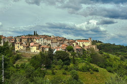 View of the hill with houses and the bell tower of the city of Scansano in Tuscany.
