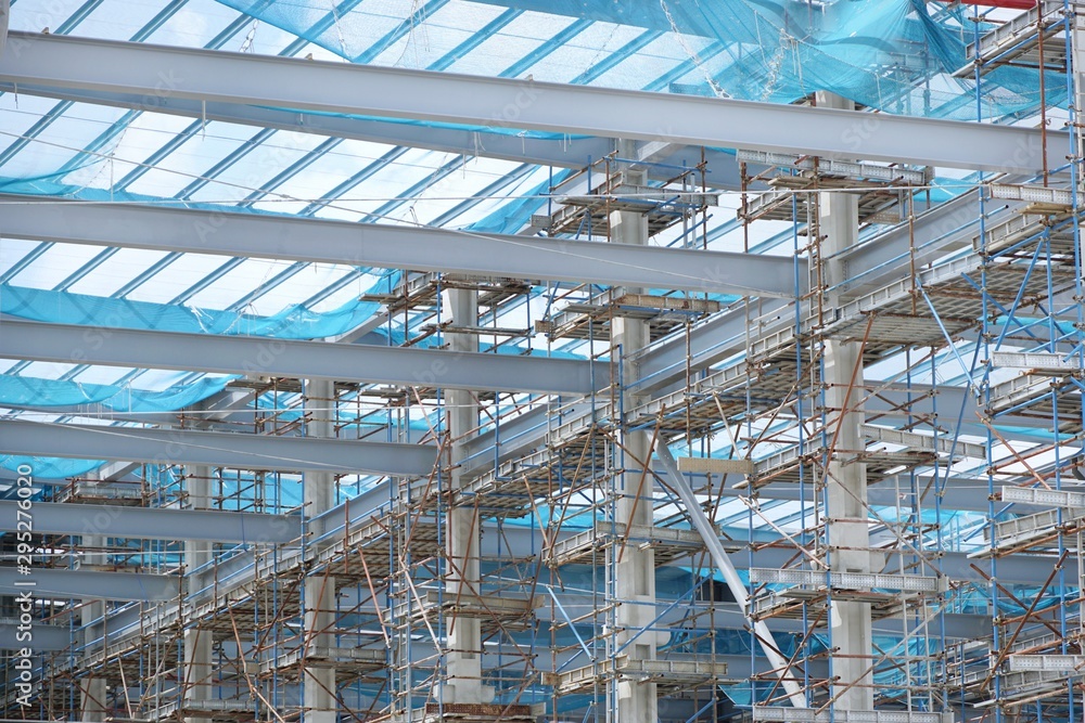 The structure of building as a background, Steel construction in large construction site, Space for text in template The structure of building as a background, Steel construction in large construction site, Space for text in template