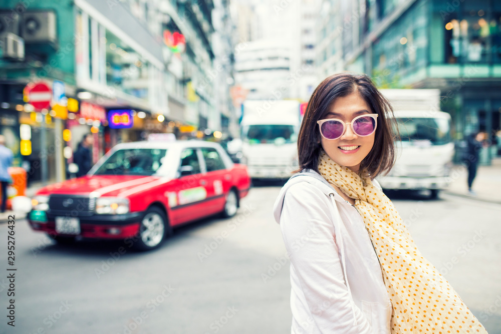 toothy smiling face happiness emotion of asian woman standing on hongkong city street