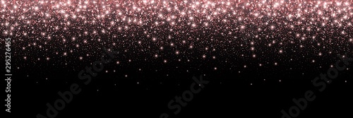 Rose gold glitter partickles isolated on black background. Pink backdrop shimmer effect for birthday cards, wedding invitations, Valentine's day templates etc. Falling sparkling confetti.