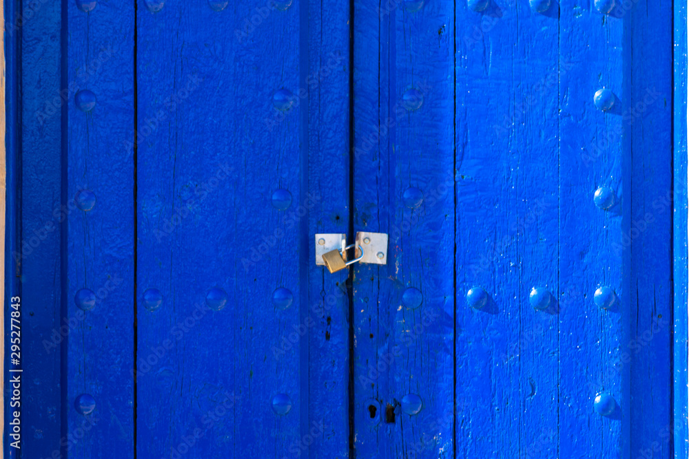 old blue wooden door with metallic lock old blue wooden door with metallic lock