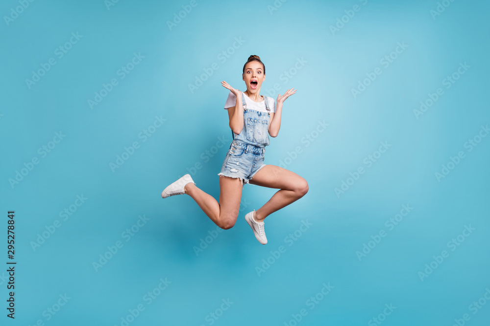 Full length body size photo of delighted astonished amazed girl seeing something unbelievable while isolated with blue background