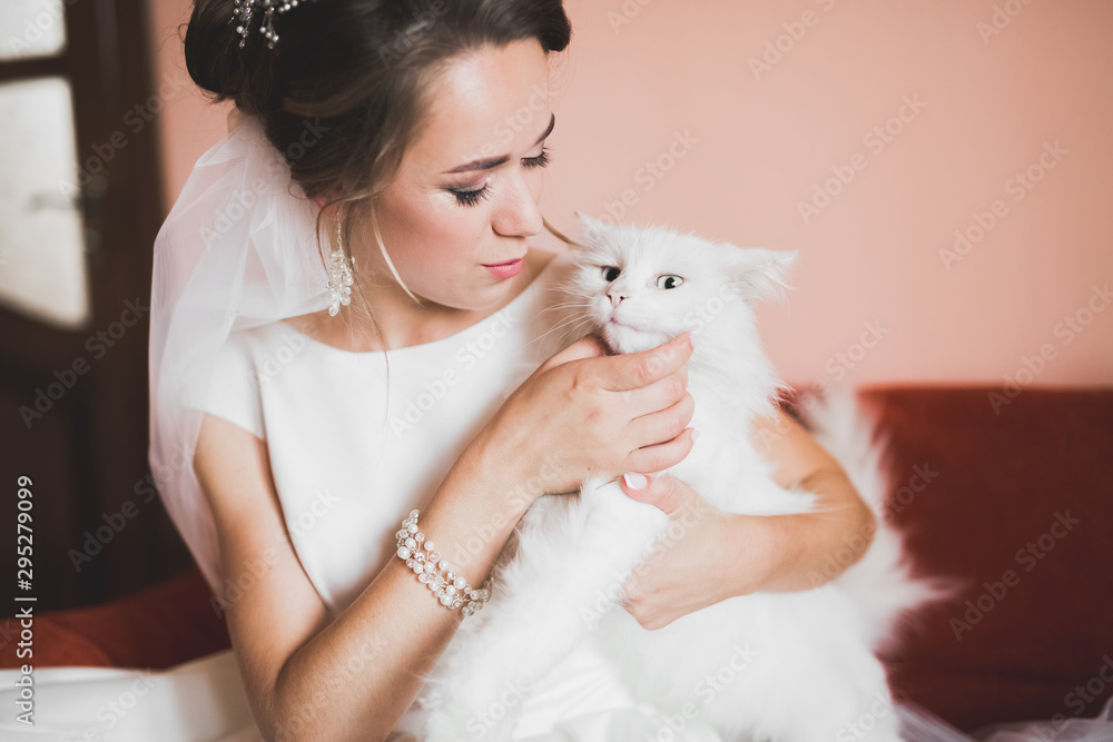 Beautiful bride wearing fashion wedding dress with feathers with luxury delight make-up and hairstyle, studio indoor photo shoot Beautiful bride wearing fashion wedding dress with feathers with luxury delight make-up and hairstyle, studio indoor photo shoot