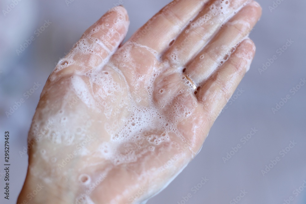 Cream shampoo in women's hands. Body care