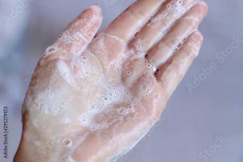 Cream shampoo in women's hands. Body care