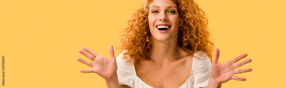 happy woman with red hair gesturing isolated on yellow happy woman with red hair gesturing isolated on yellow