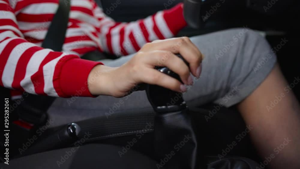 Woman fastening car safety seat belt while sitting inside of vehicle before driving Woman fastening car safety seat belt while sitting inside of vehicle before driving